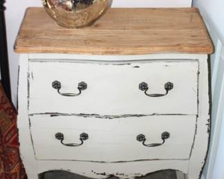 Bedside table with drawers shown with mercury glass lamp.