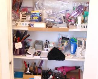 Bathroom is packed with toiletries and useful items.