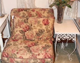 Upholstered chair shown with side table.