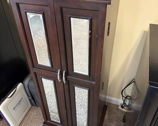 Large Jewelry cabinet that has material made inside that keeps jewelry from tarnishing.