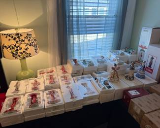 Table full of Thomas Kinkade and Hamilton Collection  brand Porcelain figurines new in the box.