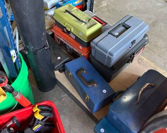 Below a table are a lot of empty toolboxes that we emptied, but some of the toolboxes are still filled and selling that way