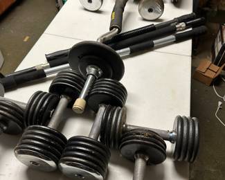 This is an entire banquet table STRAINING under the weight of these dumbbells and bars!