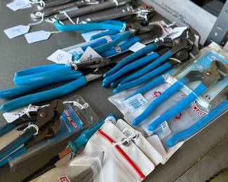 This is one of two tables filled with mint unopened channel. Lock tools and upper left corner are massive craftsman tools.