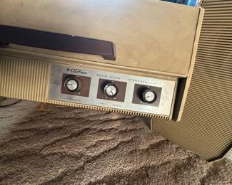 A vintage Montgomery Wards Portable stereo with attached speakers.