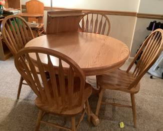 Oak table with four chairs, one leaf.  41” round with 18” leaf.  Presale $175