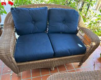 WICKER LOVE SEAT. $100. AS IS. BOTTOM NEEDS TO BE RETIED.