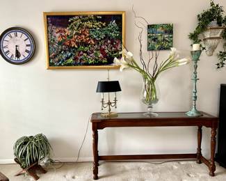 Great selection of decorative pieces and art for your home! Or great gifts for your loved ones! Next to the clock, a beautiful oil painting of flowers.