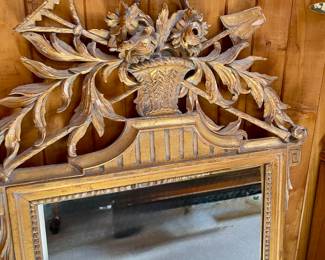 This is a Louis XVI style giltwood mirror.