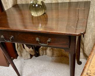 This is a Georgian-style side table with a single drawer, cabriole legs, and pad feet.