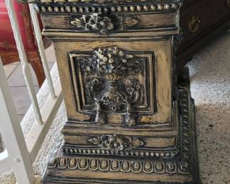 Impressive, classic, heavy, beautiful, bronze pedestal having a raised vase of flowers all around it. 