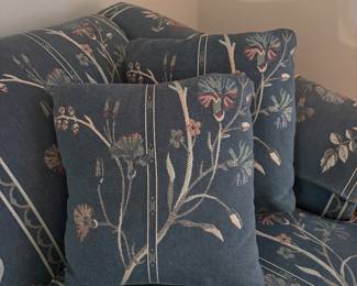 Pretty couch done in a denim blue with embossed florals