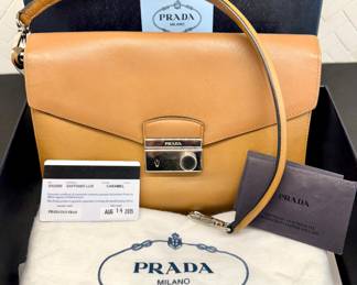 $200; authentic Prada Saffiano Lux bag with dust cover and box, has interior attached wallet (as is--missing one of the hooks to attach strap); 10x7