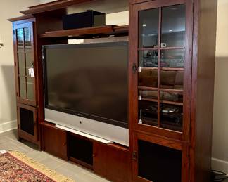 $550; 3-Piece media cabinet by Laurier with glass front doors; 108x21x77. Electronics sold in-person at sale.