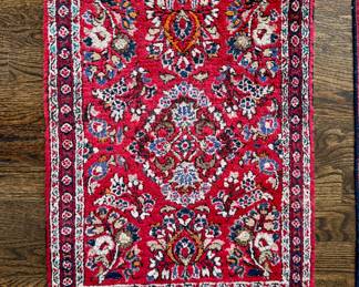 $150; wool, hand-knotted, fringed throw rug with bright accents; 2'x3'