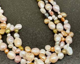 $100; genuine pearl three-strand necklace