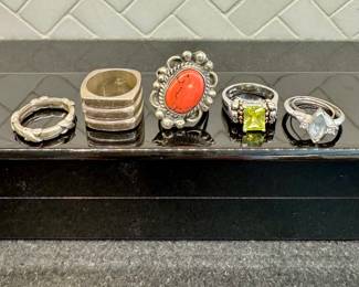 $230; Tiffany sterling band.   SOLD; sterling silver ring.    $60; coral and sterling silver ring.     $50; peridot and electroplated 18K yellow and white gold ring.     $100; 10K white gold and moonstone ring.