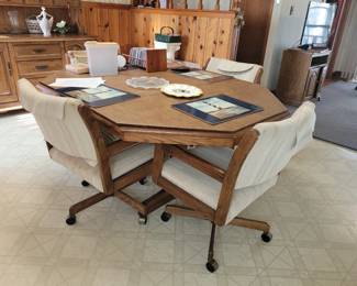 Oak and glass octagon shaped kitchen table and 4 rolling chairs 
