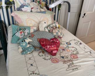 Iron bed, embroidered bed coverlet, quilt pillows