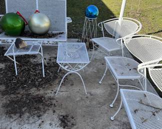 White metal patio chairs and tables
