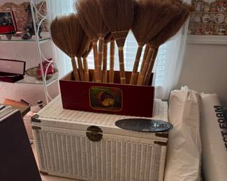 Brooms/whisks and wicker trunk