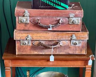 Old luggage, record players, brass buckets, Lane side table