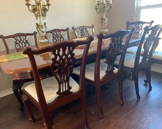 Double pedestal dining table with two leaves, six side chairs, and two arm chairs