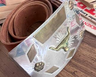 Big brass and silver belt buckle with thick leather hand tooled belt.. .HOOK EM HORNS!