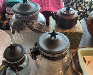 Three-piece glass canister set with metal lids.