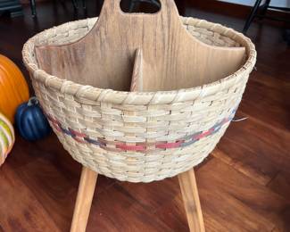 Wicker sewing basket with legs.