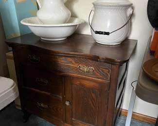 Antique farmhouse-style chest; vintage pitcher and basin; antique chamber pot.