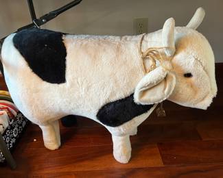 Large stuffed/plush cow, possibly a footstool.