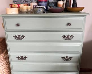 Four-drawer dresser painted in a shade of green.
