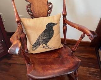 Vintage Stickley-style rocking chair; burlap throw pillow with crow motif.