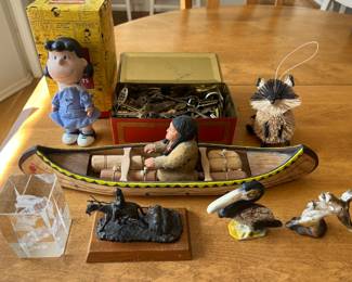 Interesting selection of “smalls,” including a Hallmark Peanuts Gallery Lucy figurine, a tin full of vintage/antique keys, vintage cast iron bottle openers (pelican and donkey), a hand-carved canoe with Native American figurine, and more.