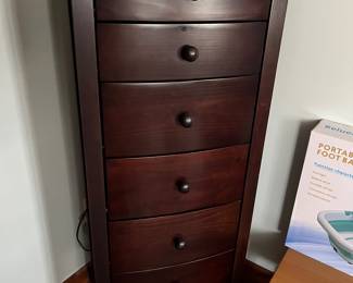 Six-drawer armoire, jewelry or similar.