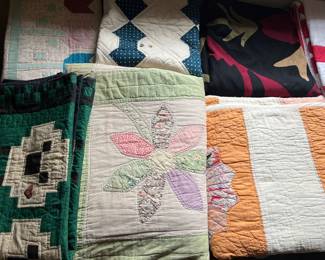 Large selection of vintage quilts. Many more shown in following photos.