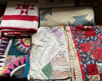 Large selection of vintage quilts. Many more shown in following photos.