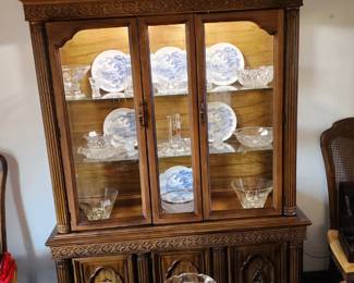 The lighted hutch is two separate pieces. The lower part has three open doors and a center pull-out drawer. The chairs include two armchairs.  