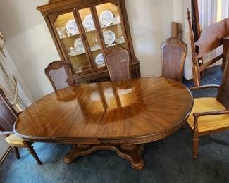 Another view of the lighted China hutch and dining table.