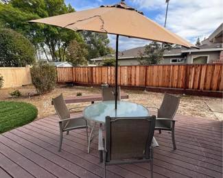 6 piece patio set. 5ft table with 4 arm chairs and 9ft umbrella with stand. In great condition.