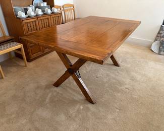 Rustic dining table shown with two extensions on each side, fully extended