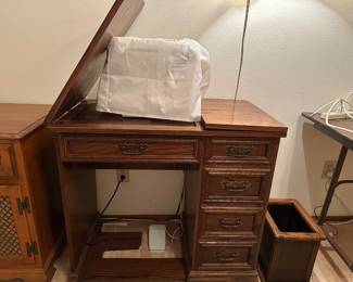 Sewing machine cabinet stand closes completely but we left it partially closed, has top piece for normal machine, this baby lock uses another custom inserted top piece, easy switch out for your machine, machine sold separately , wood trash bin