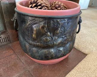Metal planter with hand engraving all around,