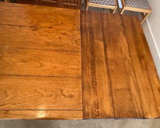 Detail of dining table side showing the two side extensions inserted, super easy in and out of extension leaves