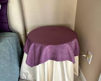 C12 - $30. Round Side Table with Purple Linens. Measures 24" round x 26" tall. 