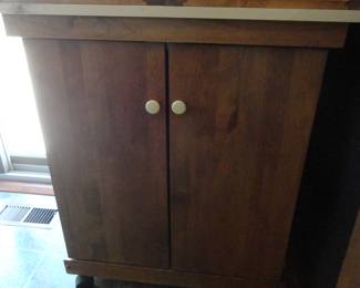 Need extra space? Top opens and cabinet on wheels