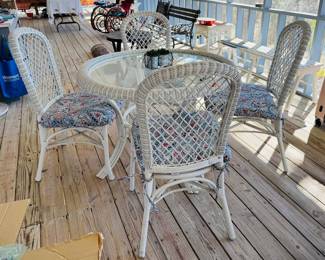 Glass top wicker table.  4 wicker chairs 