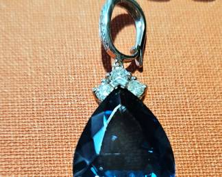 Large London Blue topaz enhancer in 14k white gold, and 14k white gold link chain in background