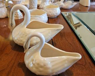 Belleek swan creamers in two sizes. One is black mark , one is brown mark.